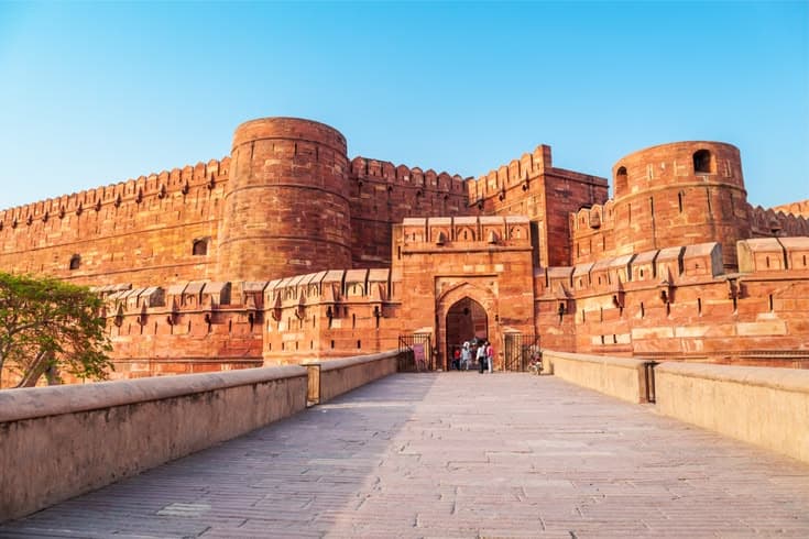 Red sandstone ramparts of Agra Fort at sunrise